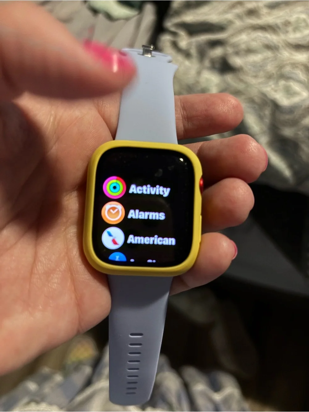 Apple Smartwatch with bag of watch covers and bands and charger.